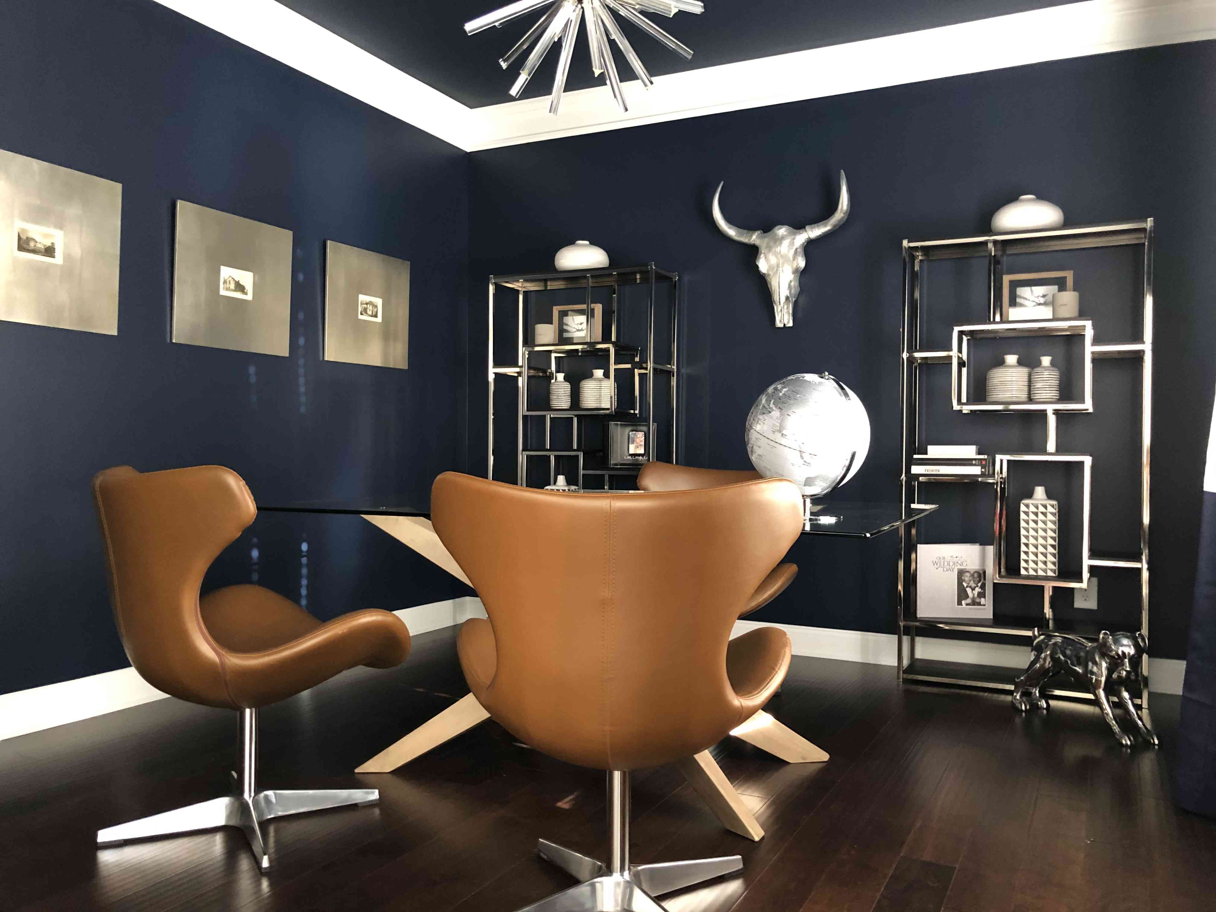 海军蓝墙壁的大胆男性化办公空间。