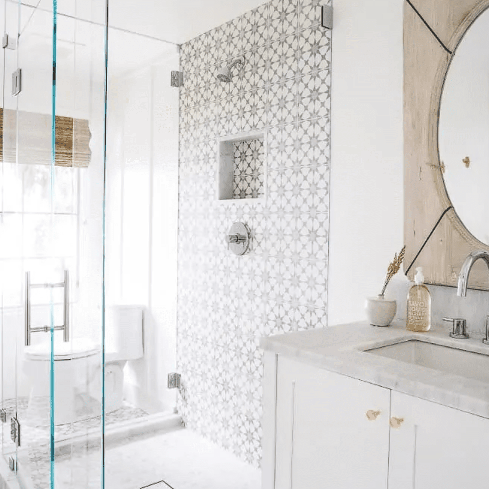 A bathroom with a boldly tiled shower wall and matching floors