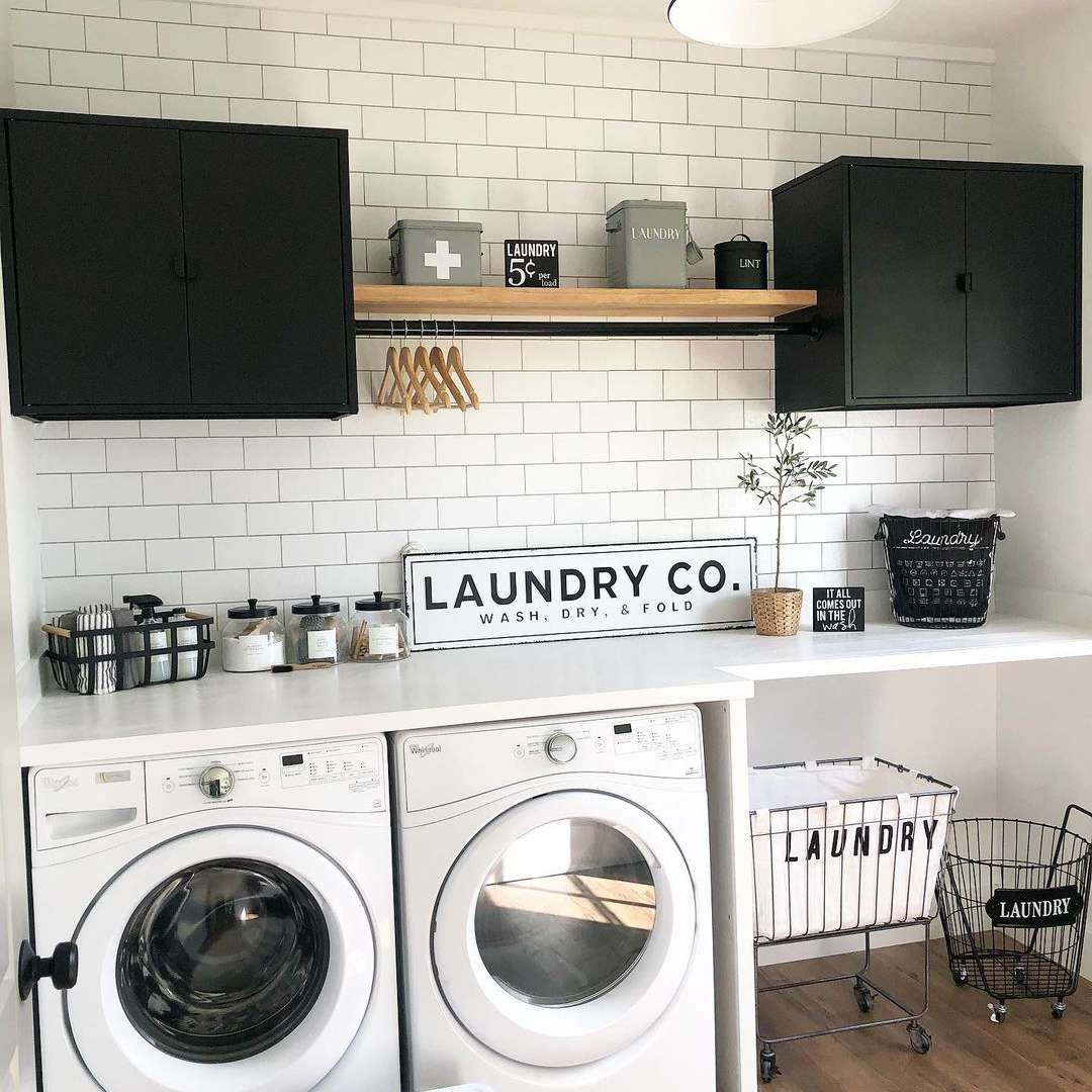 Laundry room with shelves and black cabinets