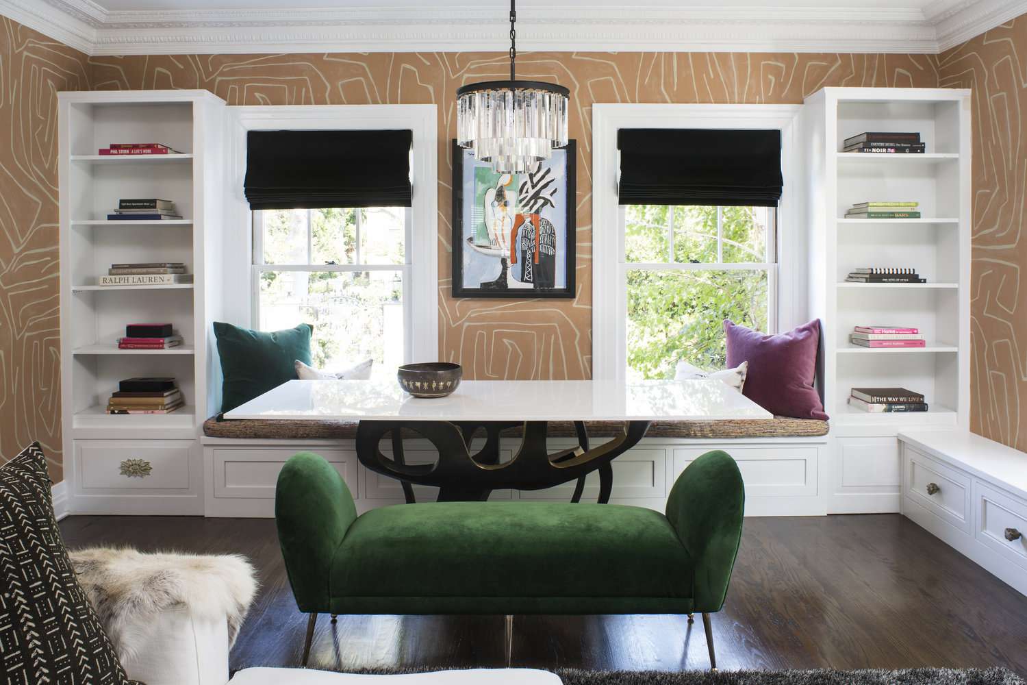 A home office with walls covered in vibrant wallpaper