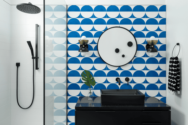 A bathroom with mod clue and white wallpaper on the walls