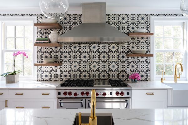 Kitchen with black and white backsplash.