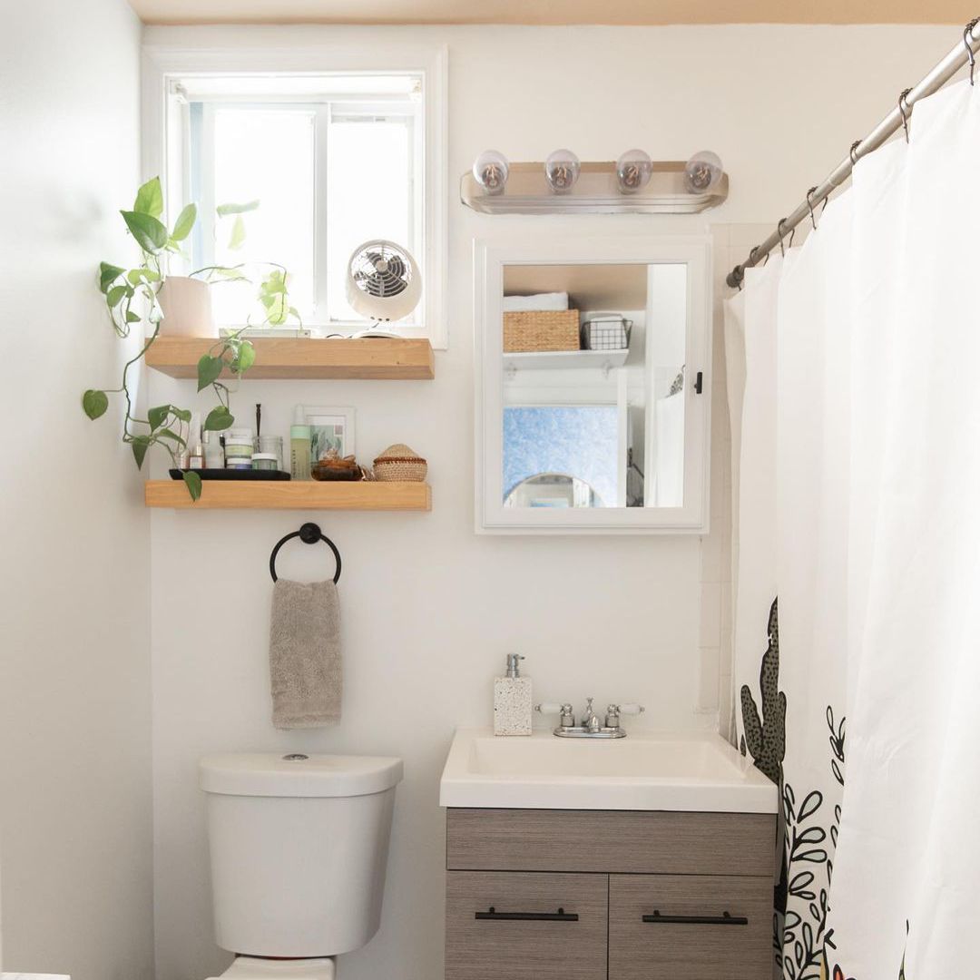 浴室里有白色的药柜和架子。