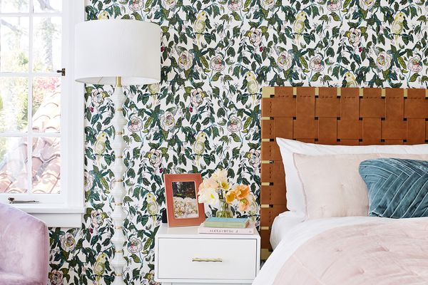 bedroom with floral wallpaper and pink bedding