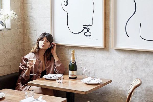 在一家餐馆喝香槟的妇女