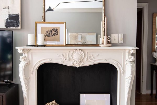 Ornate mirror on top of white mantle.