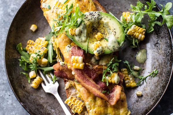 an omelette in a skillet garnished with avocado