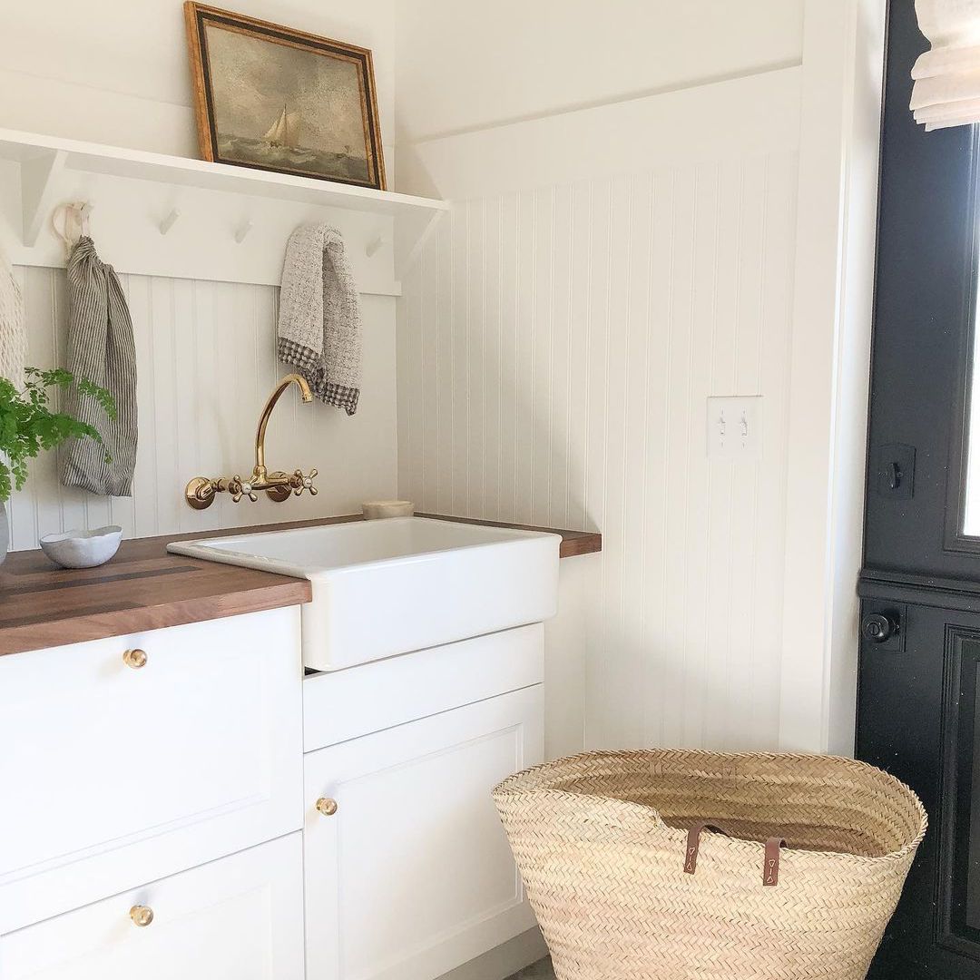 Laundry room with shelf above sink