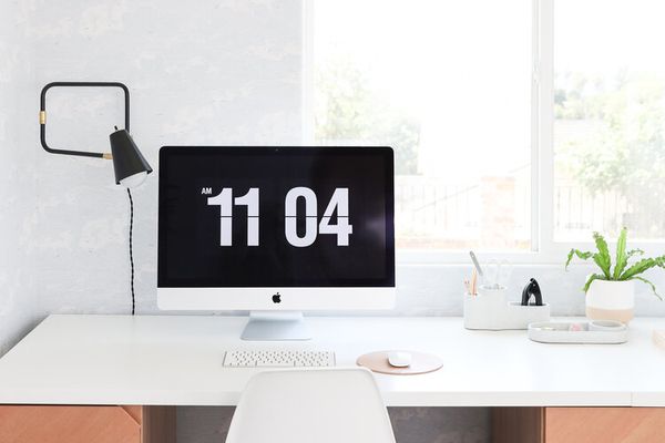 Minimalistic office space with white desk and chair.