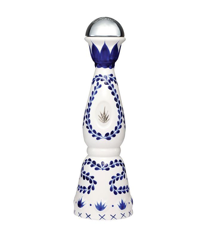 一个白色的陶制龙舌兰酒瓶，中间是一株龙舌兰，上面是手绘的墨西哥图案。