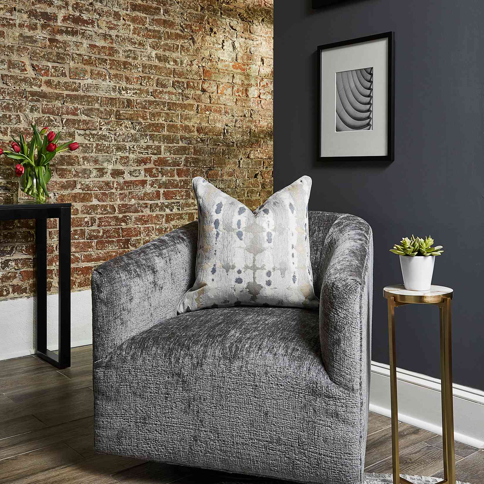 Duke Ellington home tour - cozy reading corner with an oversized chair and brick wall