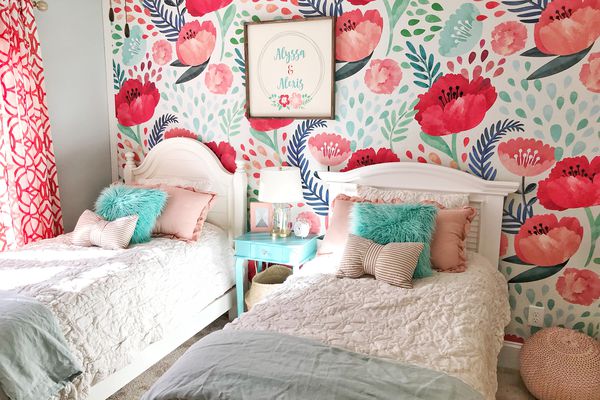 大胆和彩色的女孩卧室与花卉墙纸。