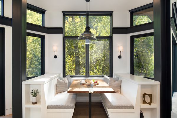 长凳座位在厨房里俯瞰着与大窗户的树木。