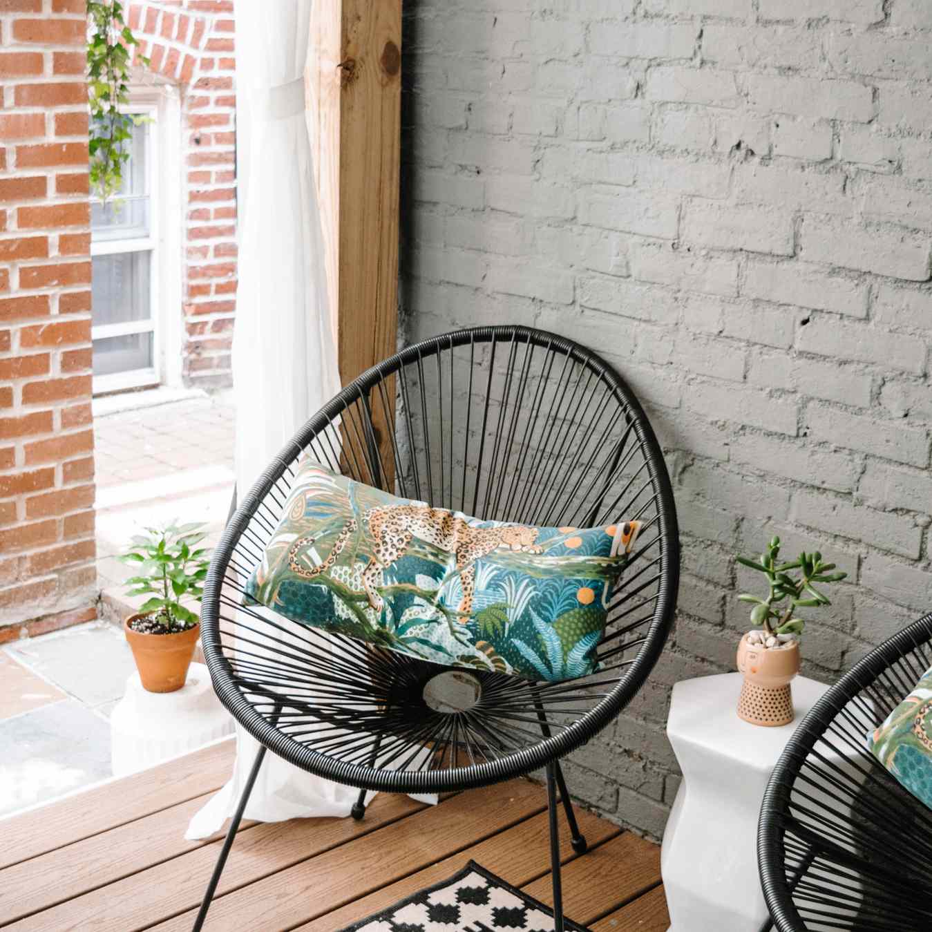 在黑色的鸡蛋椅子外面在小门廊。