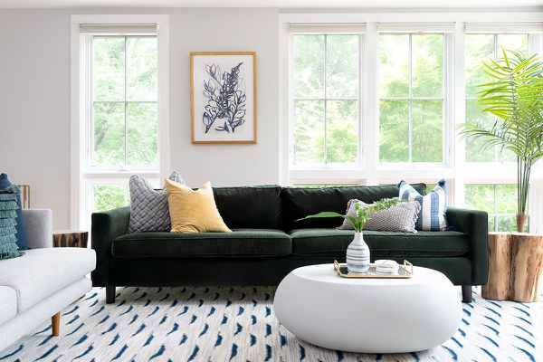 海滨别墅客厅与棕榈和绿色沙发。