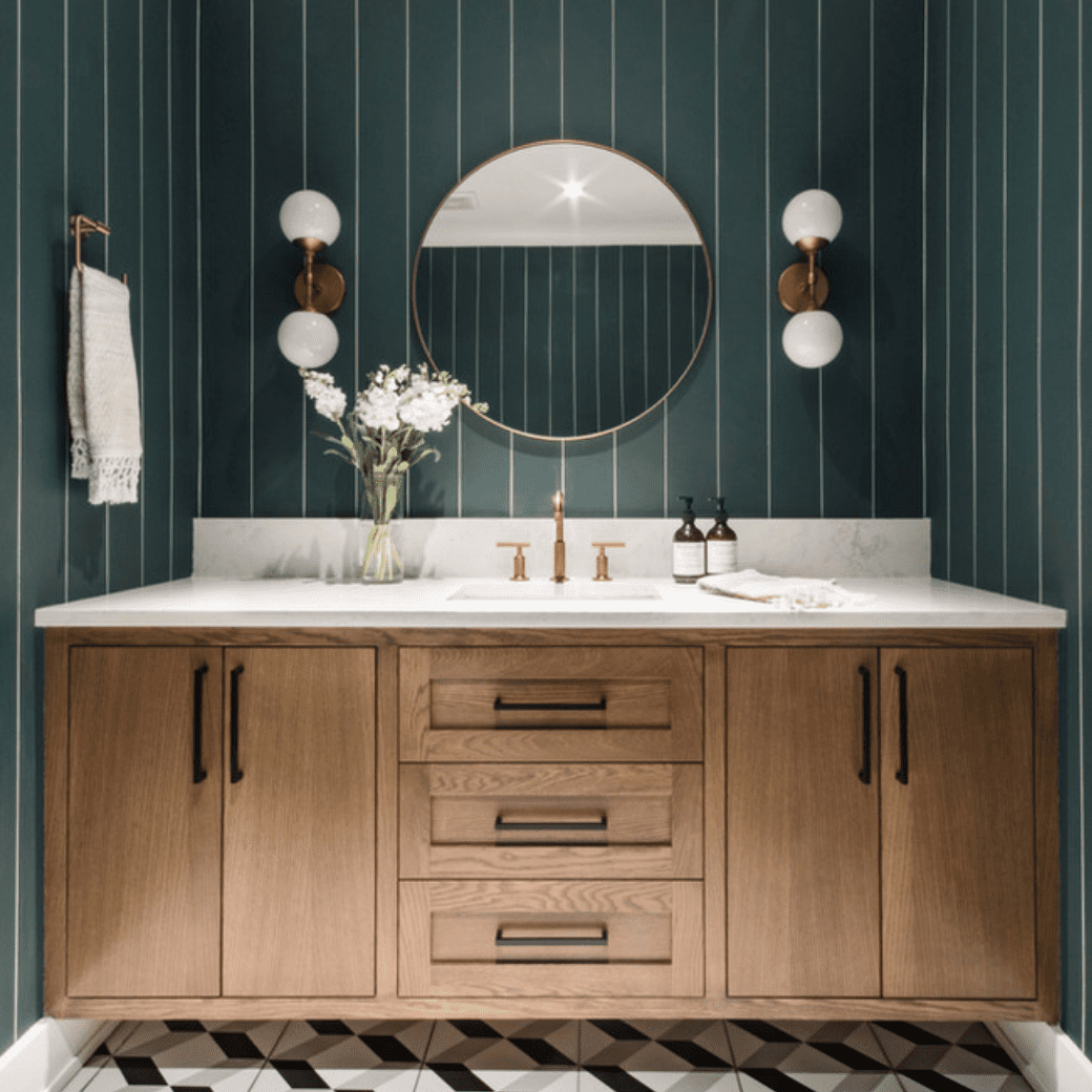 这间化妆室有深绿色条纹墙纸、黑白瓷砖地板和其他装饰艺术风格的装饰