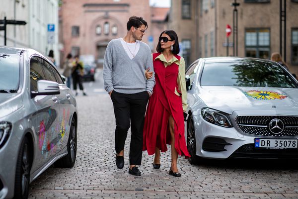 a couple looking at each other seriously in the street
