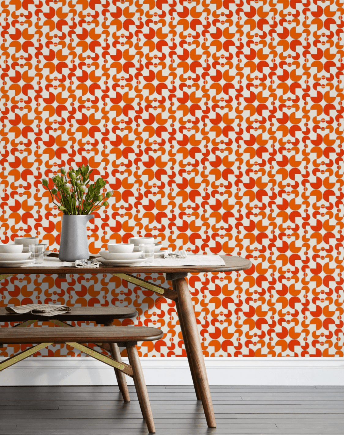 A wall covered in red and orange printed wallpaper