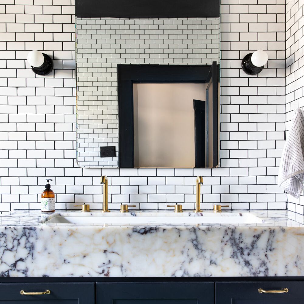 浴室后挡板内衬白色地铁瓷砖和黑色水泥