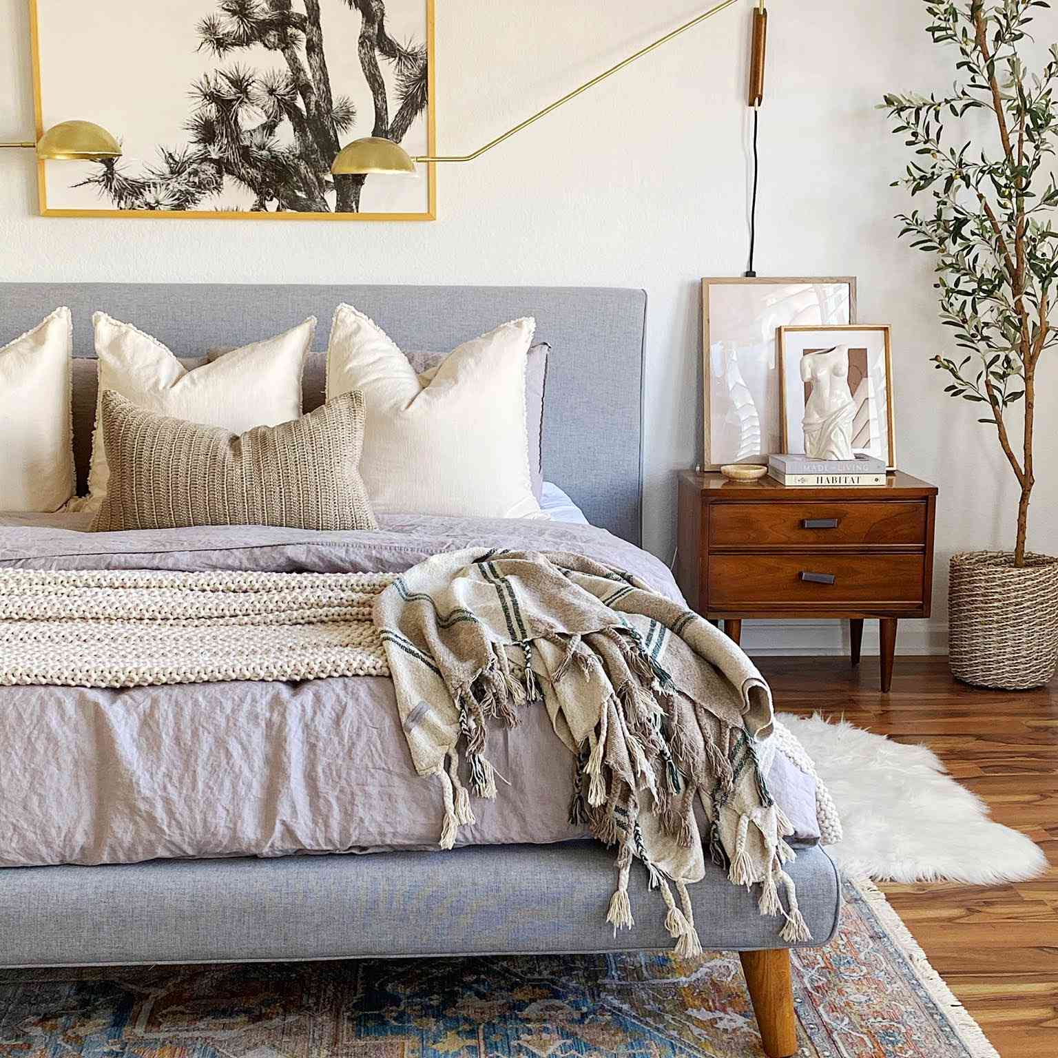 中性卧室与老式地毯和金色灯光。