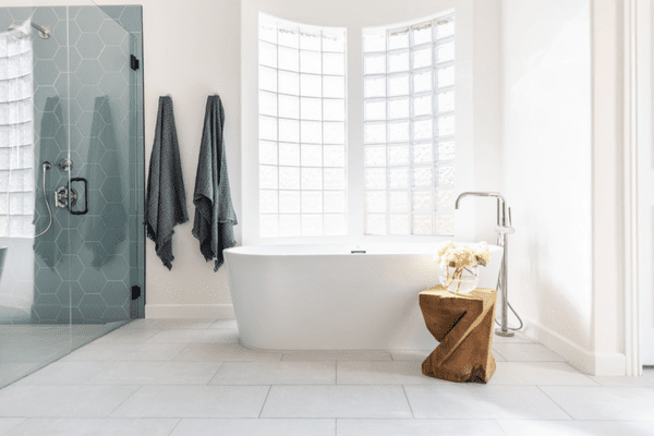 白色瓷砖浴室与蓝色瓷砖淋浴。