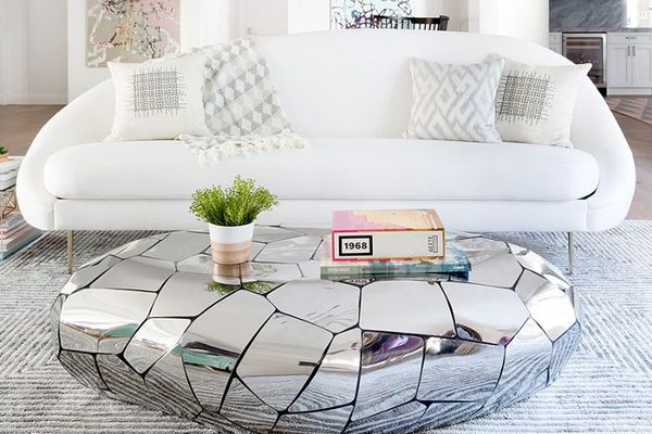 living room with white sofa and mirrored coffee table