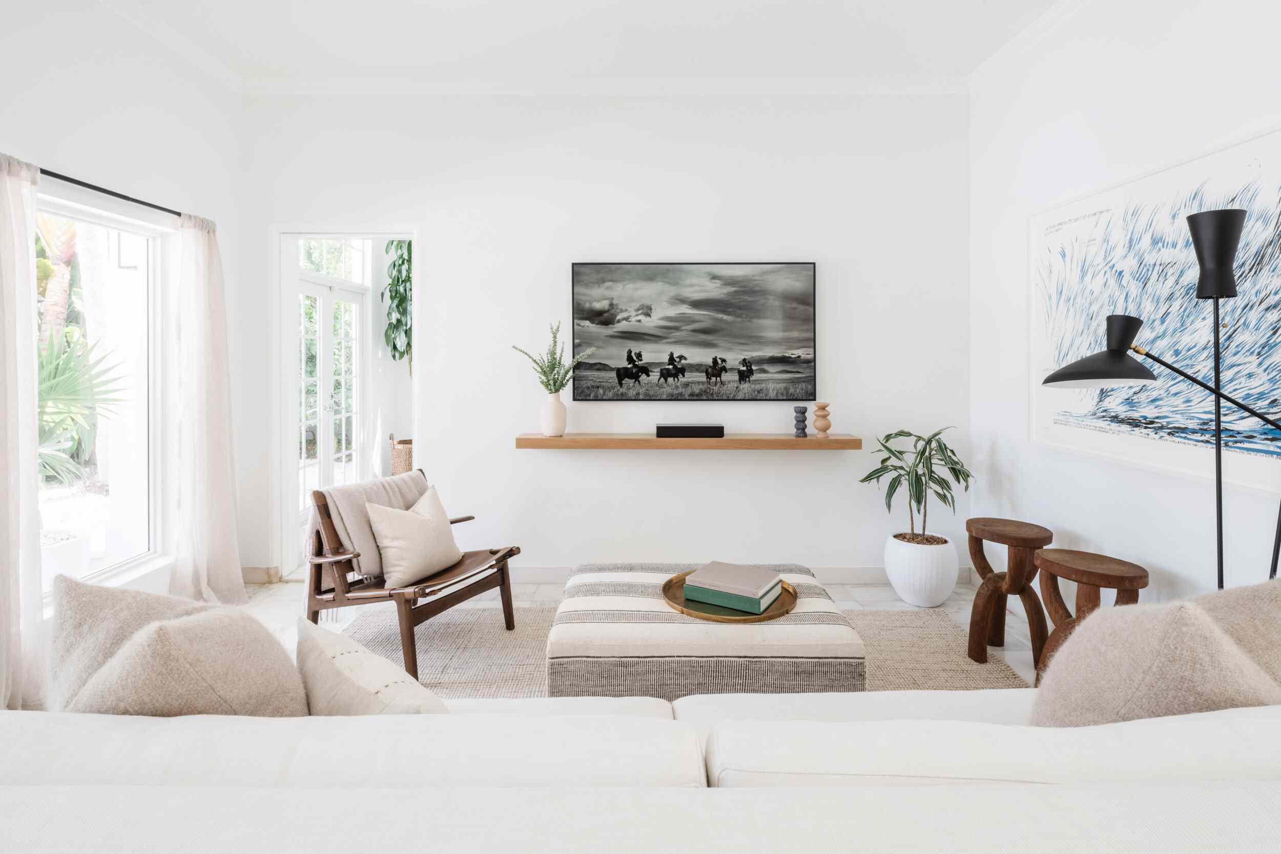 一个主要的白色起居室，带有黑白海报，从远处看石板灰色