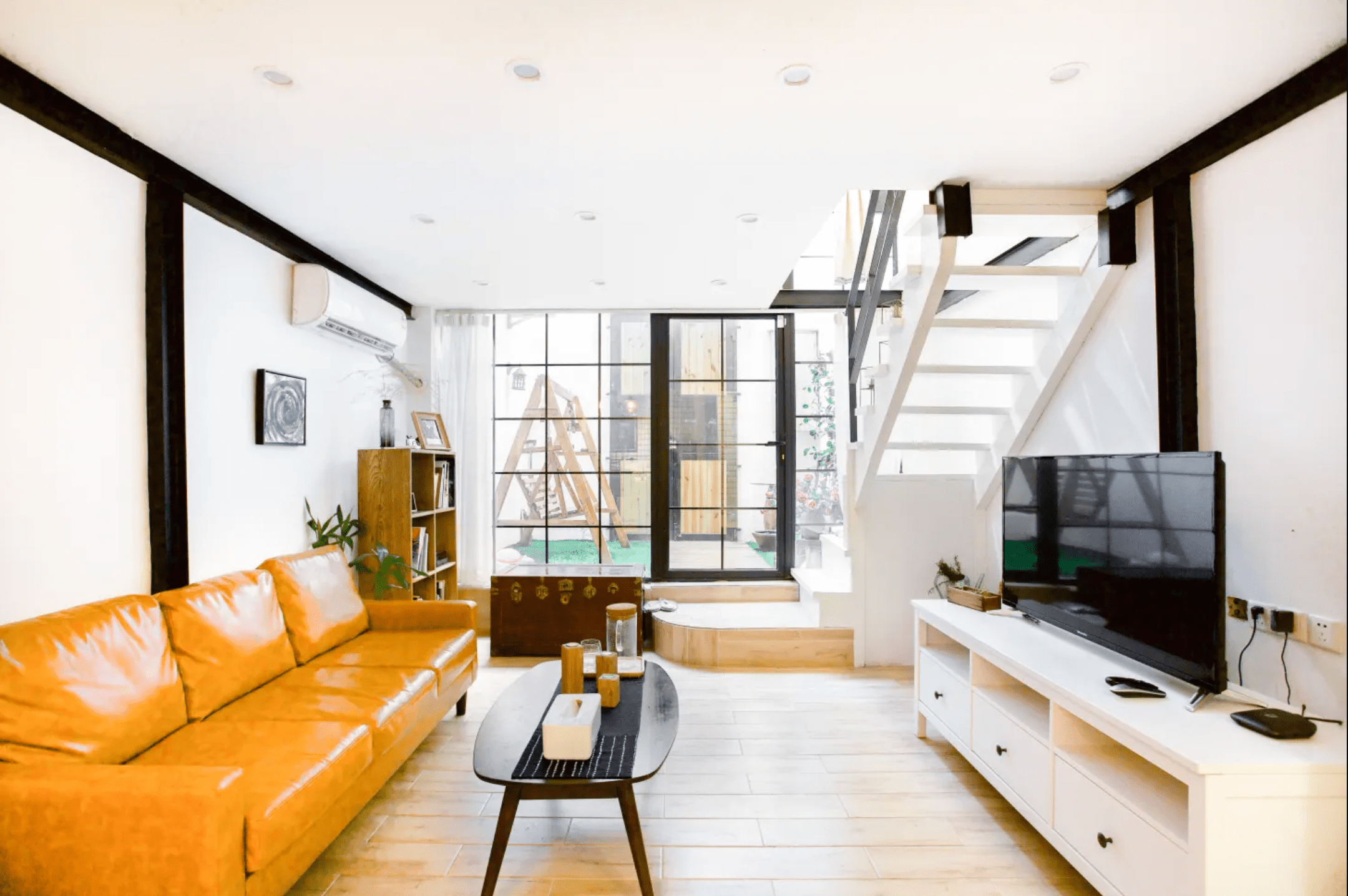 在上海的一间起居室里，媒体控制台卡在楼梯下面