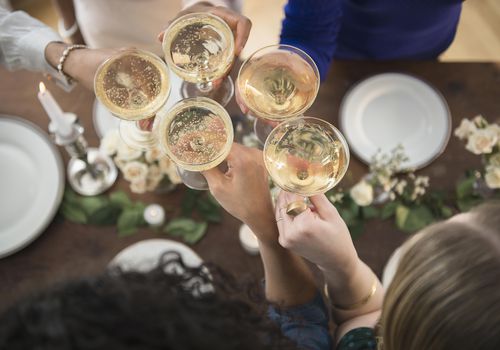 Women toasting each other with champagne