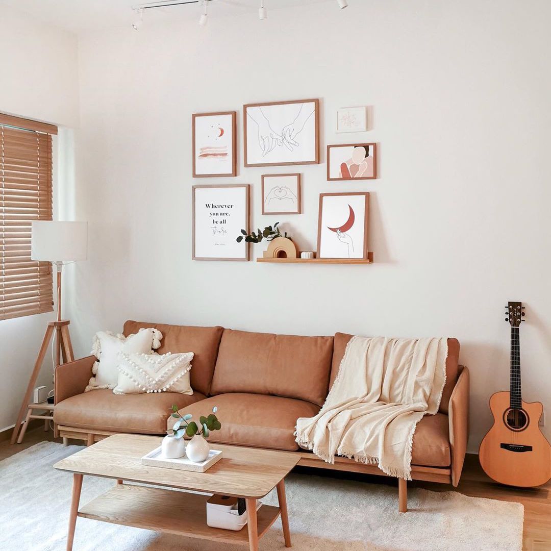 Soft pink living space with overhead lighting and corner lamp.