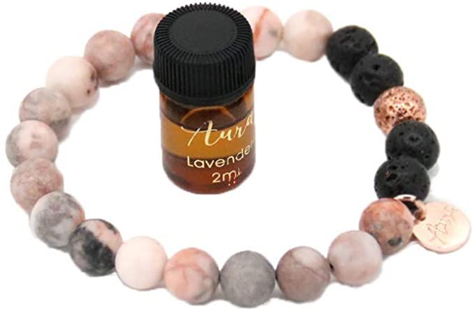 Bracelet with lava rocks, paired with a lavender essential oil.