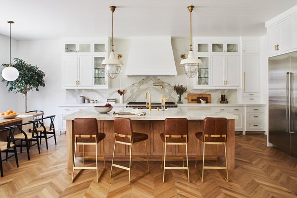 A contemporary kitchen with zigzag hardwood floors.