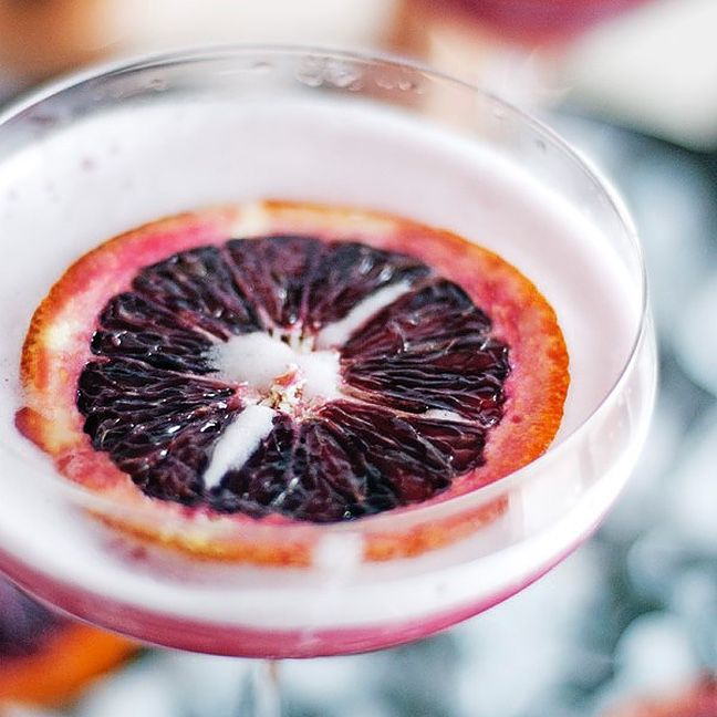 Martini garnished with blood orange wheel.“class=