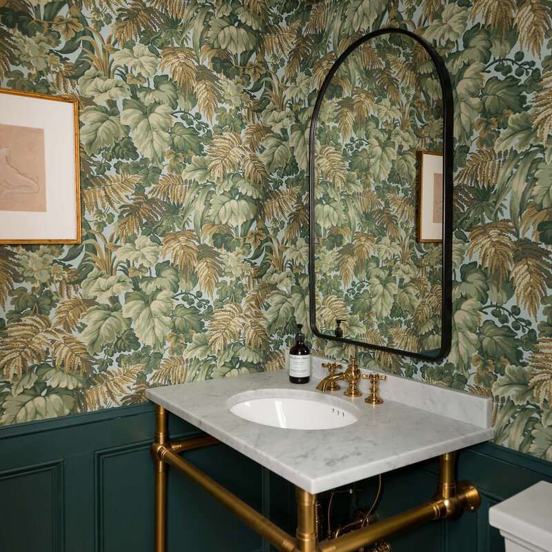 墙上有复杂的绿叶壁纸的粉末室